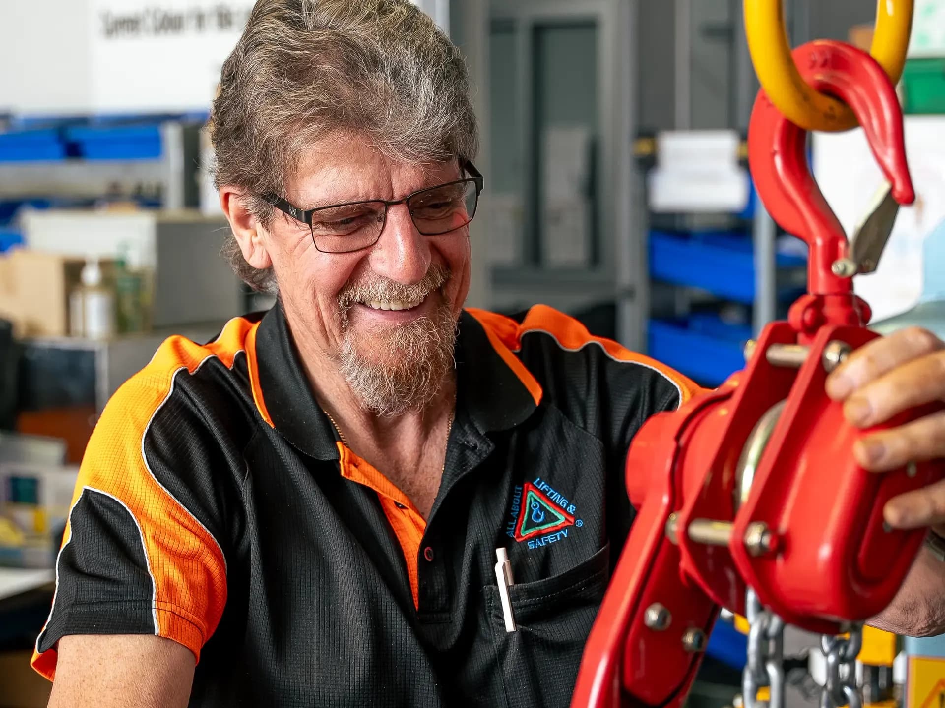 Technician checking a lever hoist and chain in the workshop