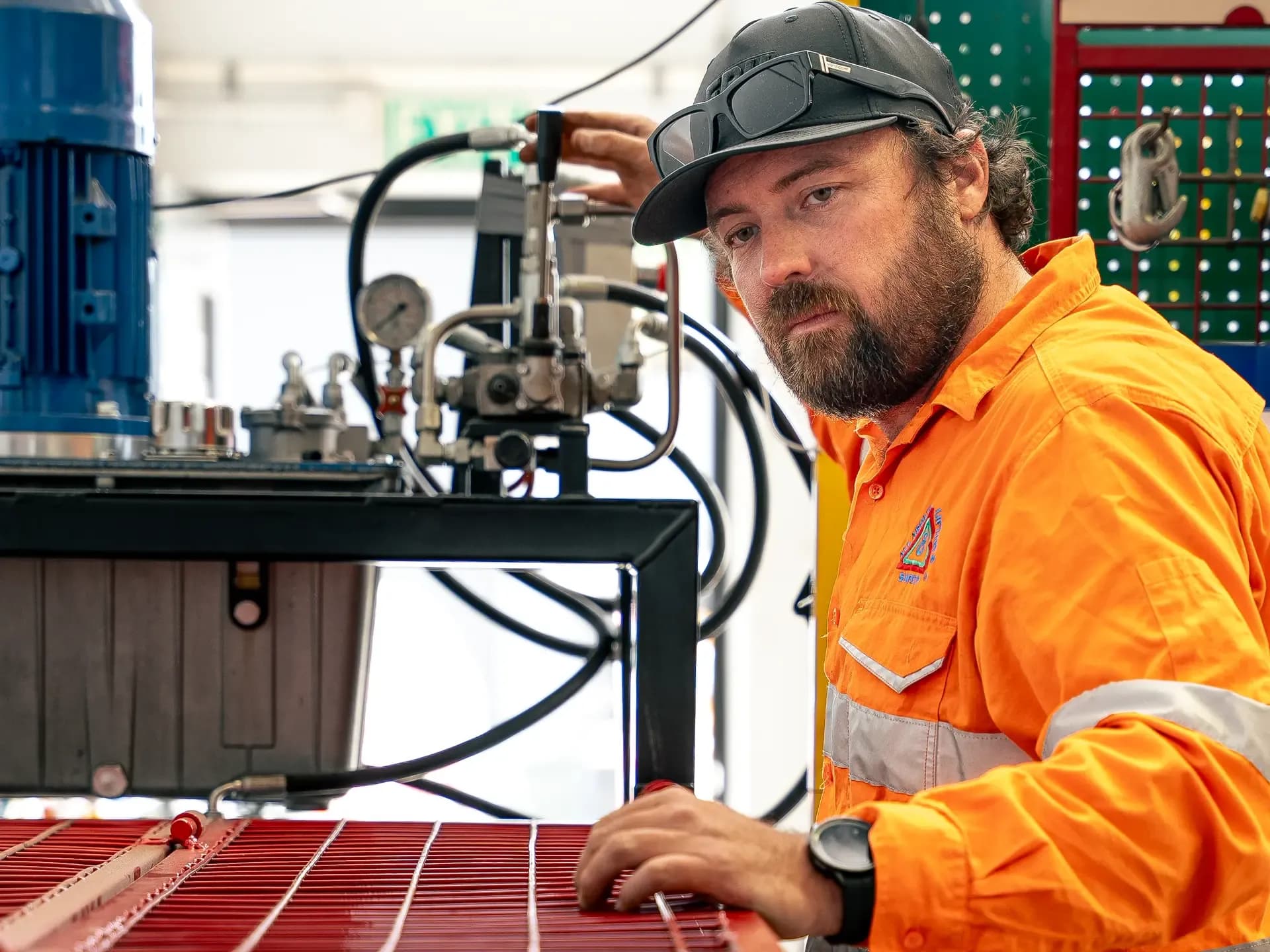 Technician running a hydraulic test rig in the workshop