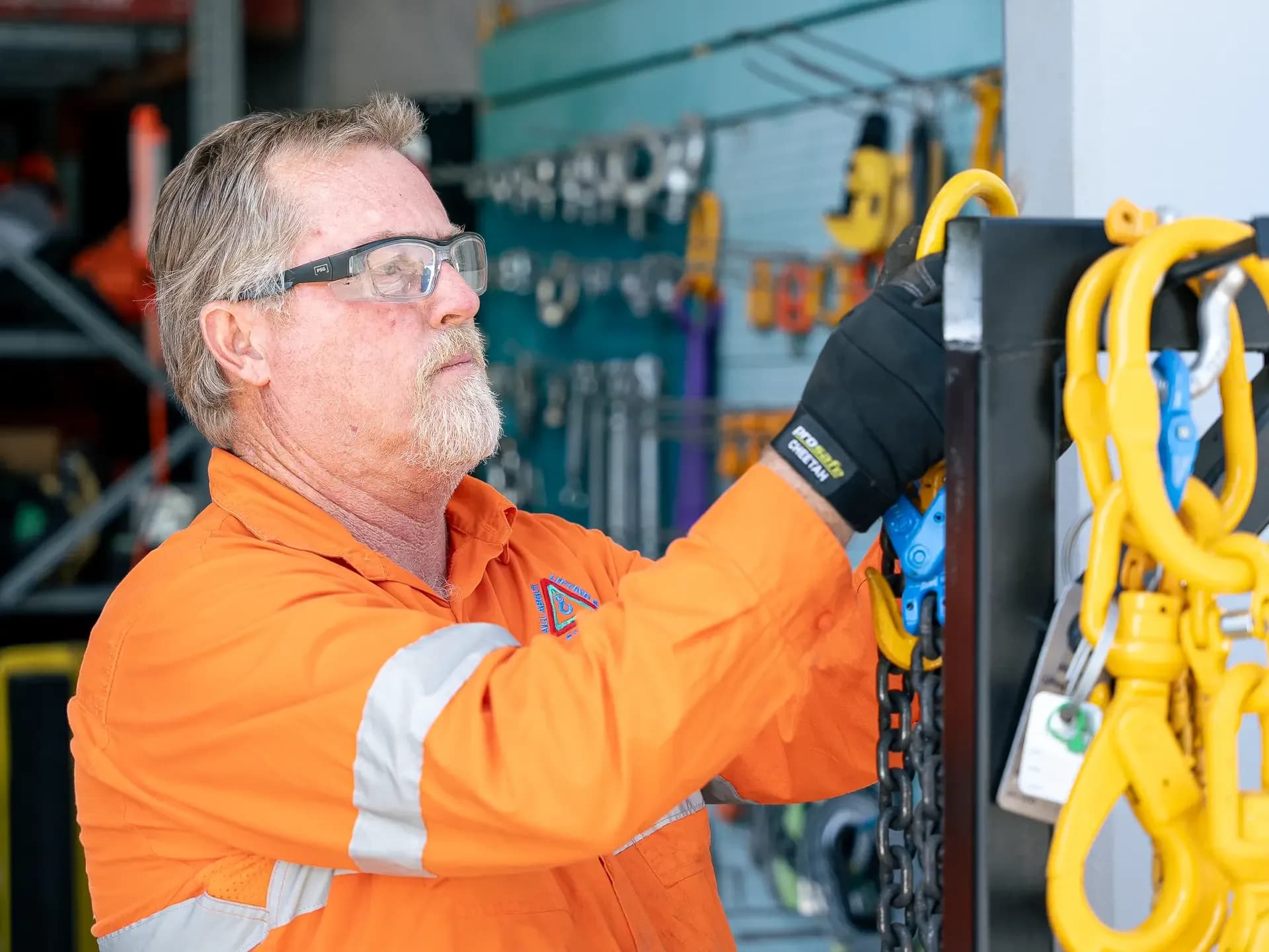 Technician checking the hooks and tag on a chain sling