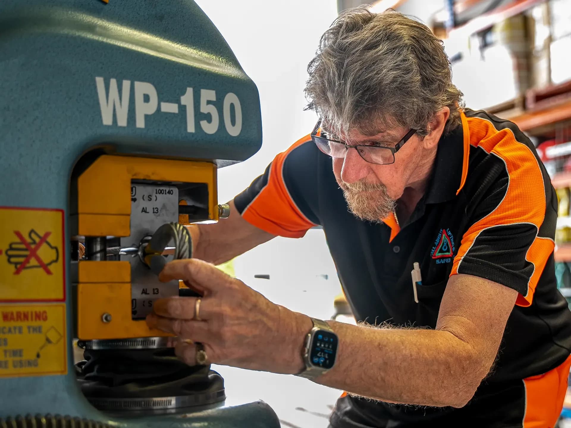 Technician swaging a wire rope fitting on the WP-150 press